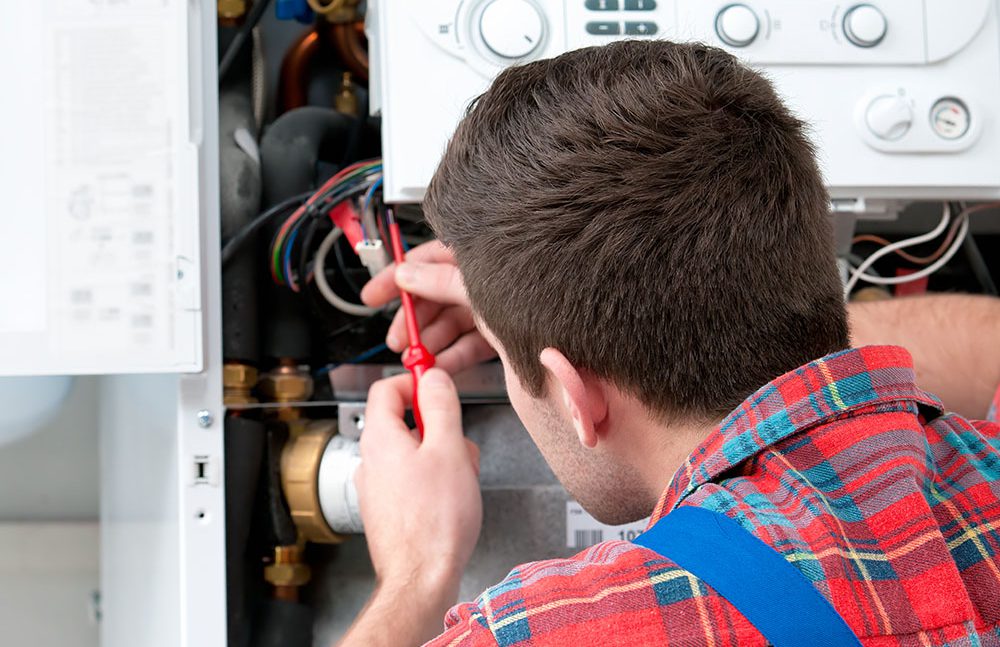 Image of a heating engineer installing a boiler