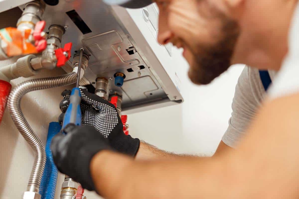 Boiler engineer working on a boiler in this image