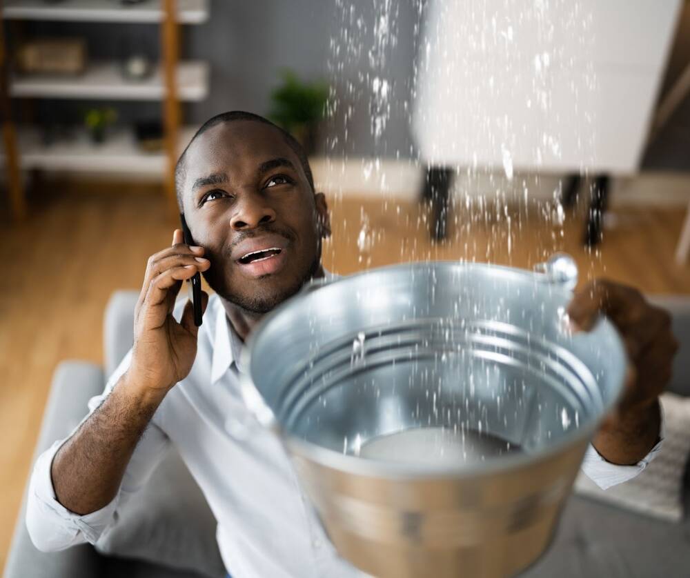 Image of man catching water in a bucket