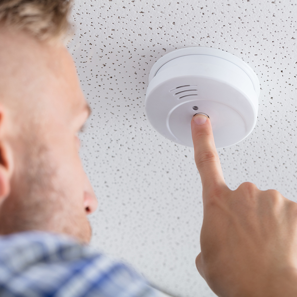 Image of a man testing a carbon monoxide detector